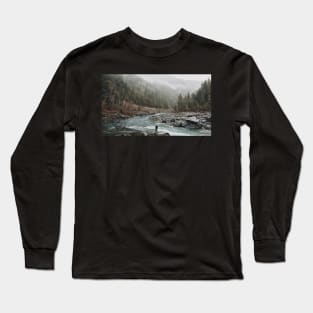 A man standing on jagged rocks in a fast-flowing river in the wilderness Long Sleeve T-Shirt